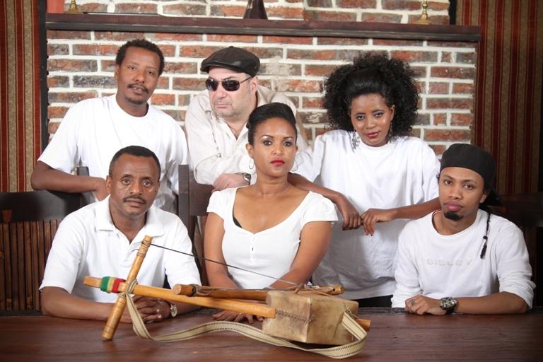 The core members of Dub Colossus pose with a messenqo (a one-string fiddle) 